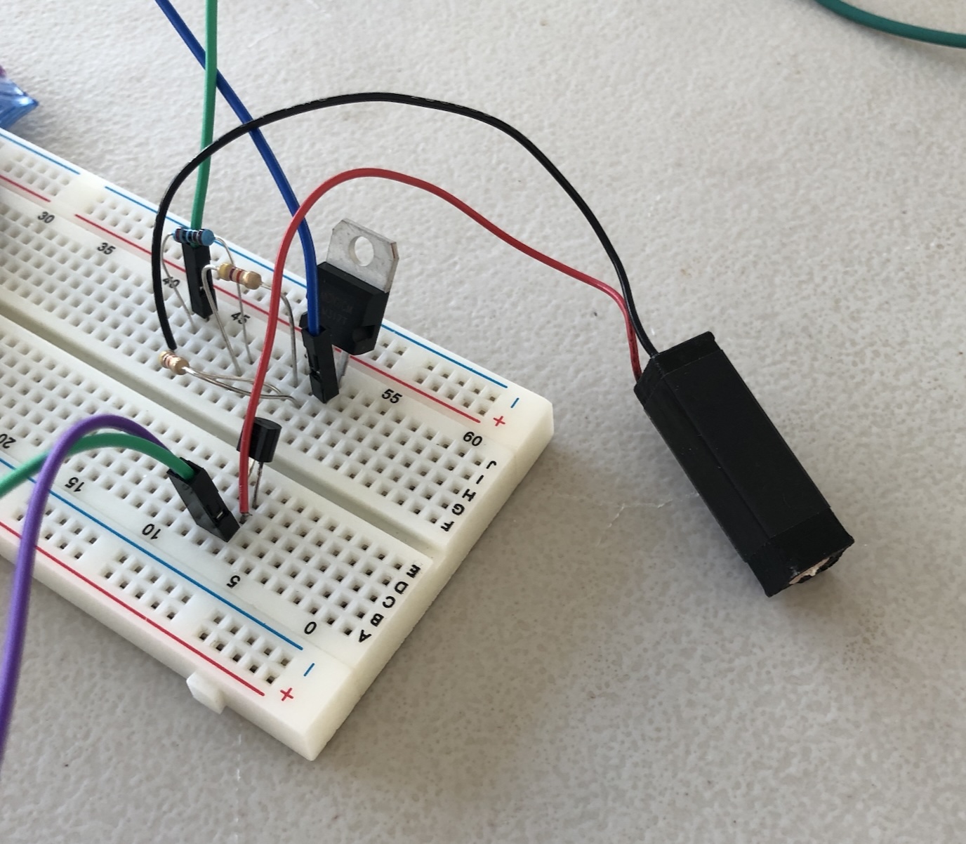Breadboard driver circuit wired to a small black voicecoil actuator for testing the Traxion effect