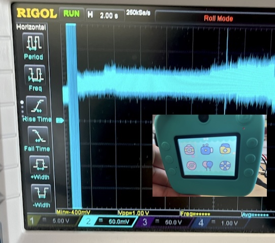 Oscilloscope current trace holding steady around 85mA with the toy camera on its start menu screen