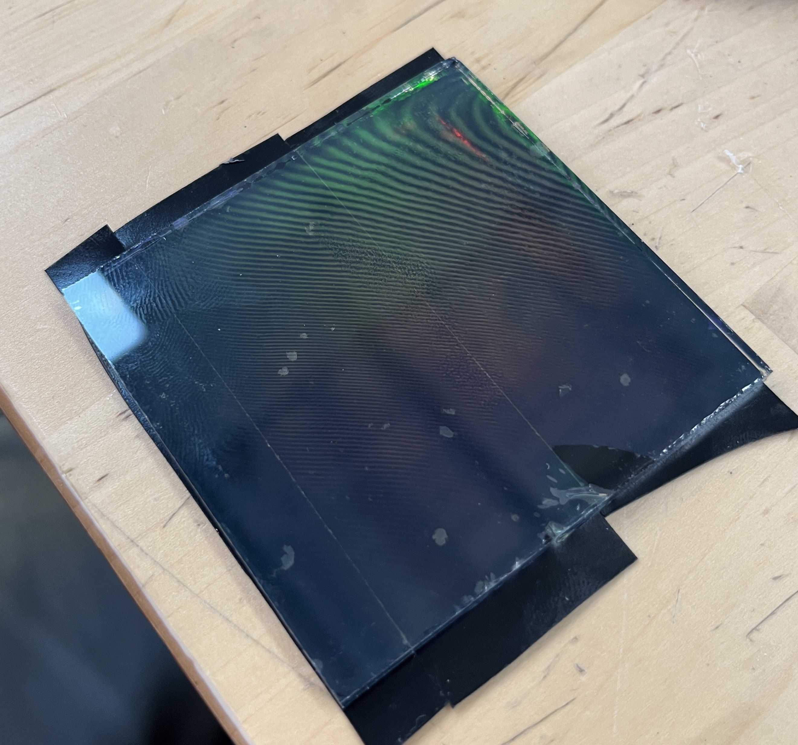 Air bubbles trapped in the tape backing. Remember manually putting on phone screens like this?