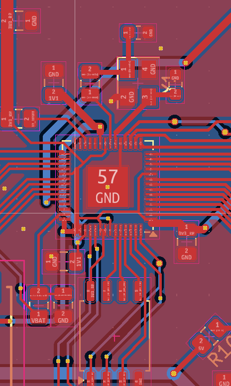 PCB layout view of the RP2040 with traces fanning out from the chip and decoupling capacitors placed nearby