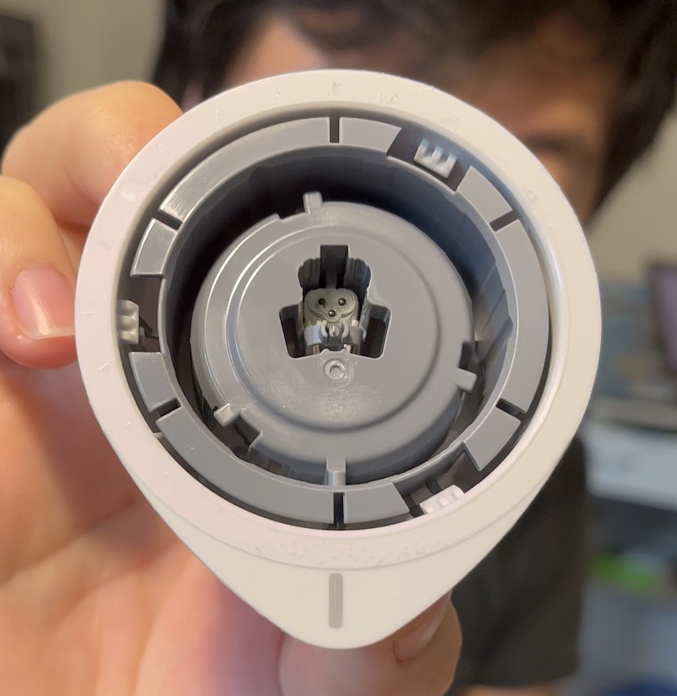 Underside of the round sensor cup with the small needle-carrying piece at its center