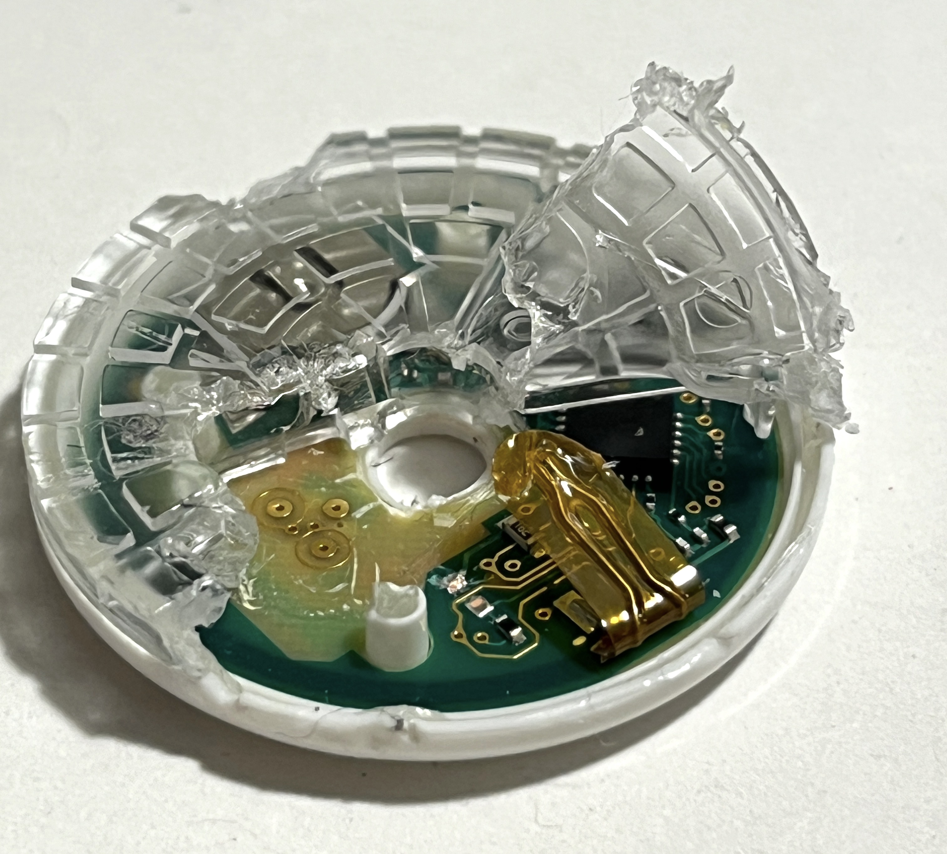 Torn-open sensor revealing a component under kapton tape, possibly a thermal resistor for skin detection