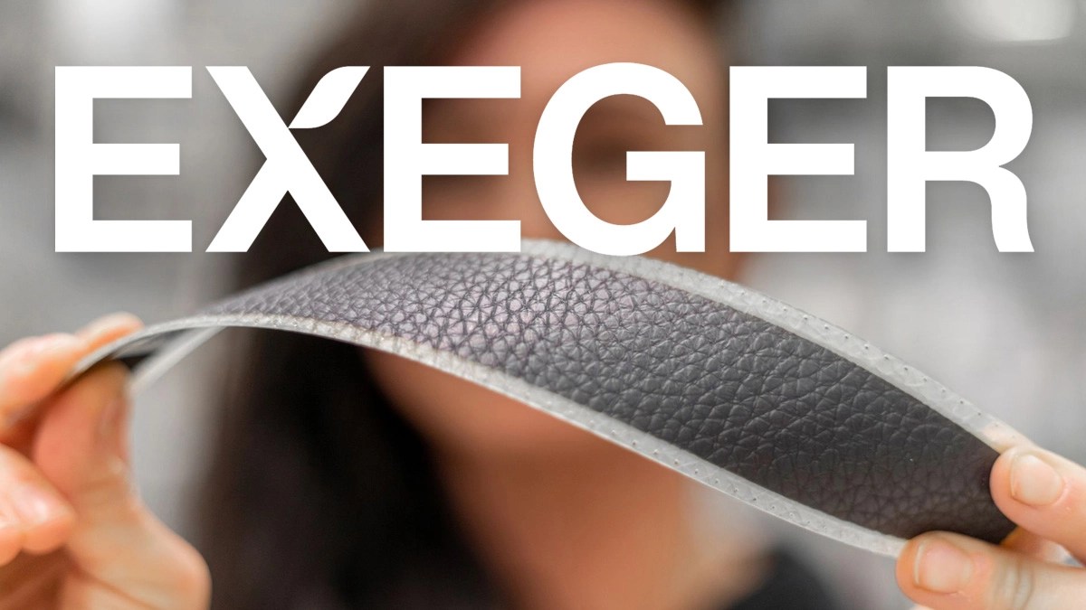 Exeger promo shot of hands flexing a leather-textured PowerFoyle solar cell strip