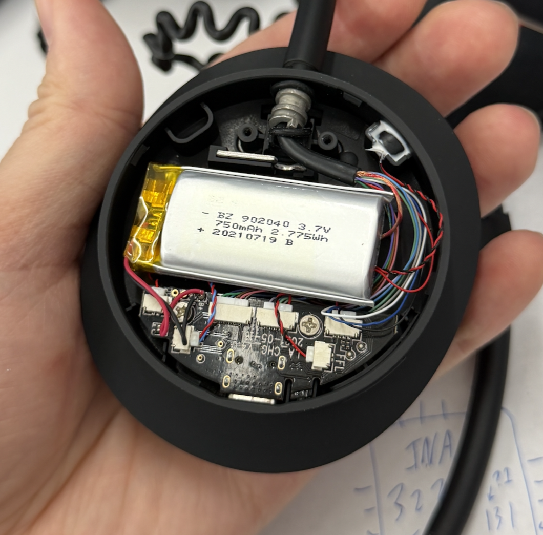 Inside the left earcup: a silver 750 mAh 3.7 V pouch battery wired to the PMIC board
